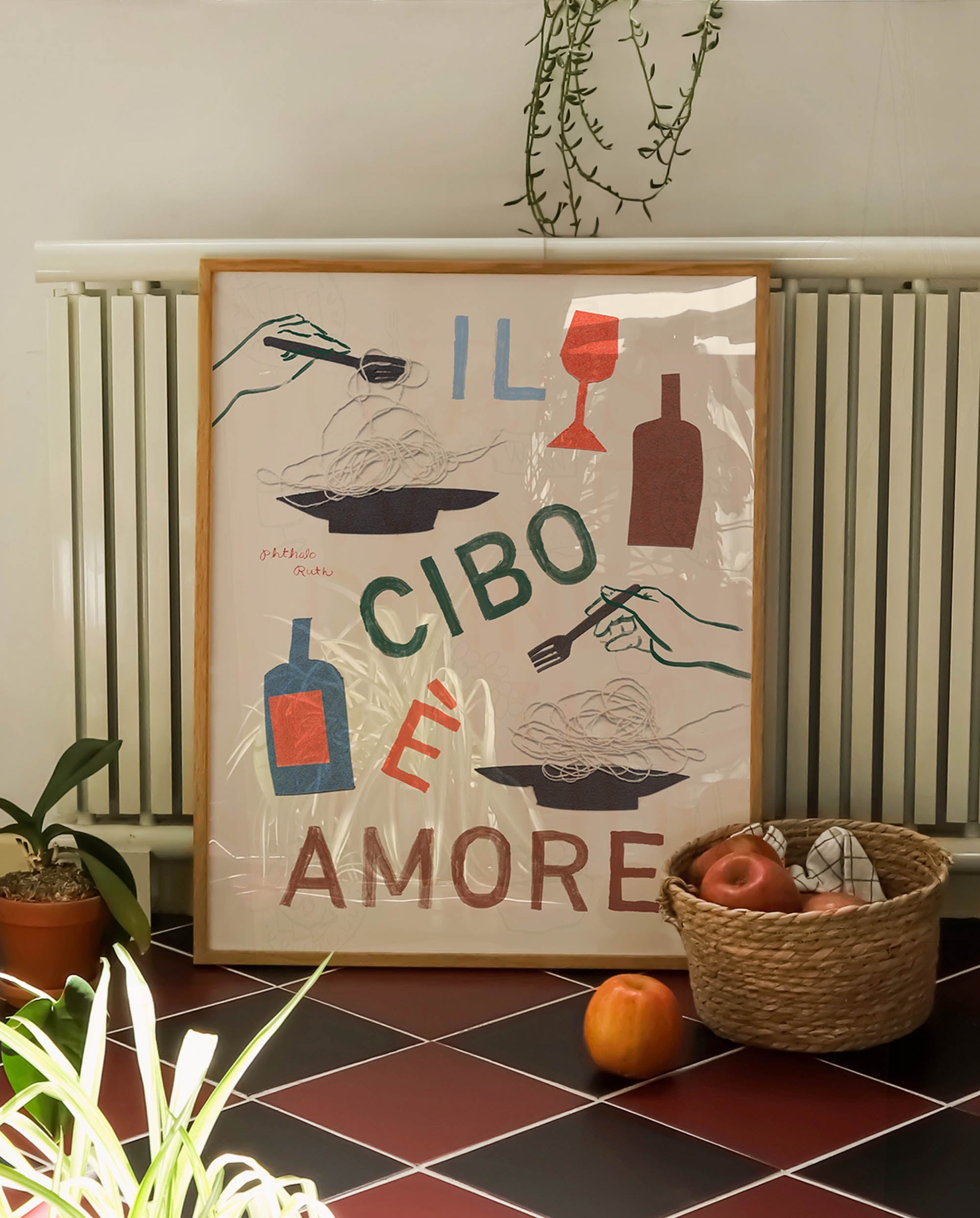 Papercut art print featuring "Il cibo e l'amore" (Italian for "Food and love") with painted details on a tiled kitchen floor. The design depicts wine, wine glasses, hands holding forks, and twirling pasta