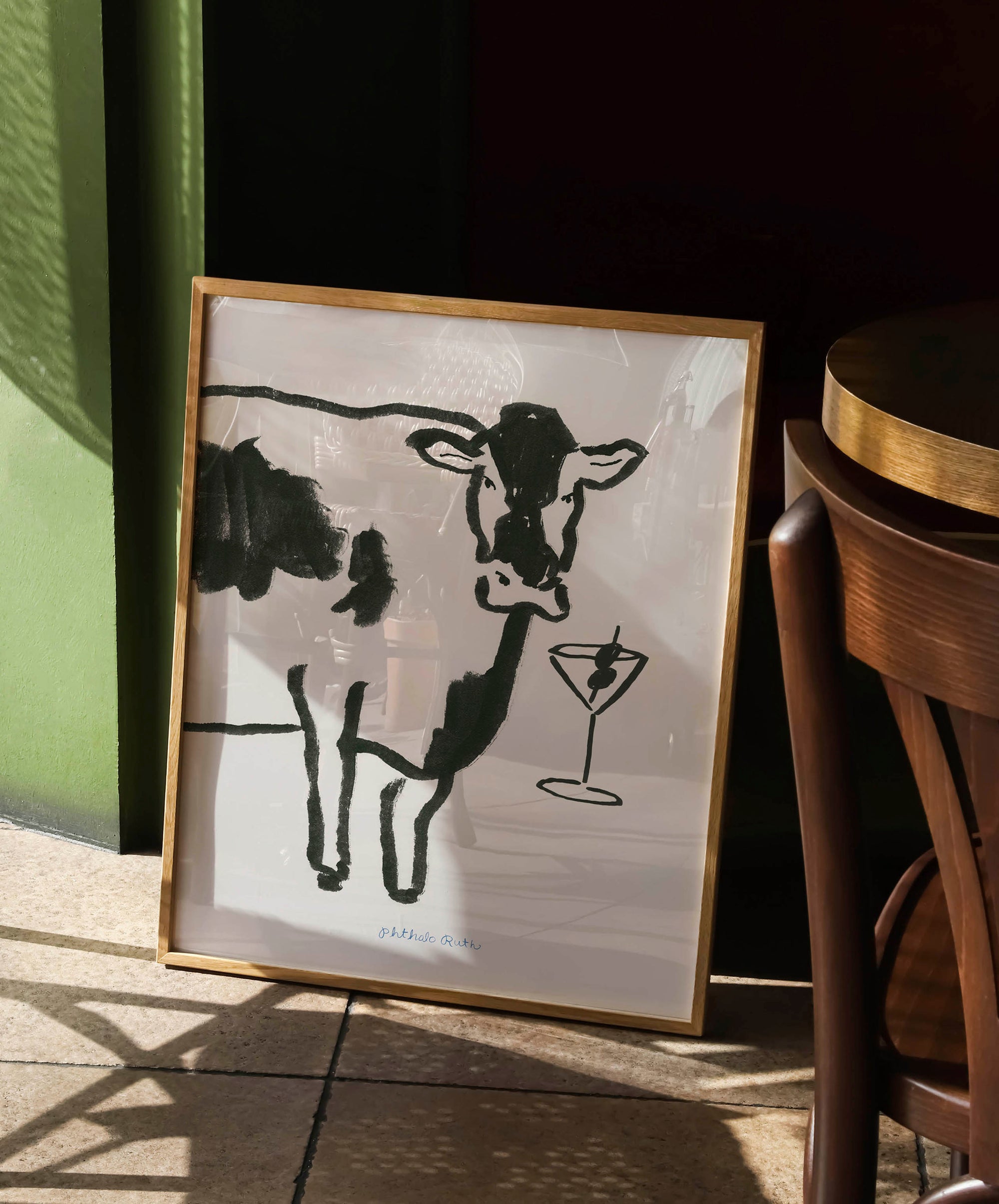 Art Print "Moo-tini" features a black and white cow with a martini glass. The martini glass has an olive skewer in it.