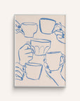 "Cafe Du Jour" features hands holding mugs in a cheerful toast hand-painted in blue, on a white background.